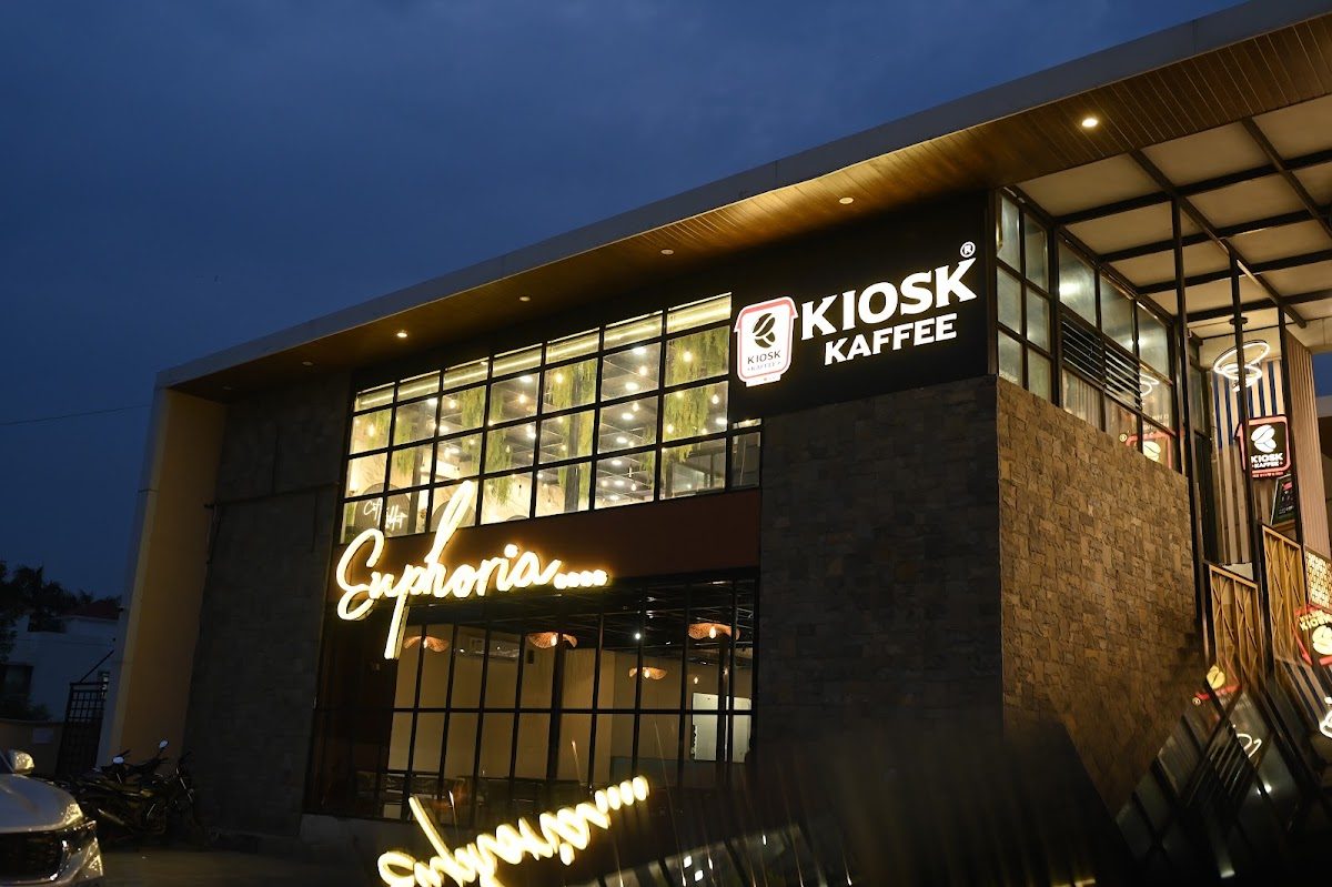 Euphoria's glass facade lit up in neon at dusk